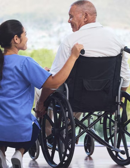 healthcare-disability-man-wheelchair-with-nurse-retirement-nursing-home-patio-senior-care-happy-disabled-grandpa-woman-caregiver-with-smile-enjoying-view-hospital-clinic_590464-89327 (1)